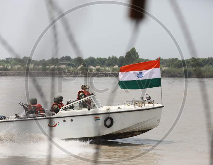 Border Security Force (BSF) soldiers patrol on a boat in river Chenab at Pargwal area along the India-Pakistan border in Akhnoor ahead of Independence day, about 55km from Jammu on August 12 ,2020.