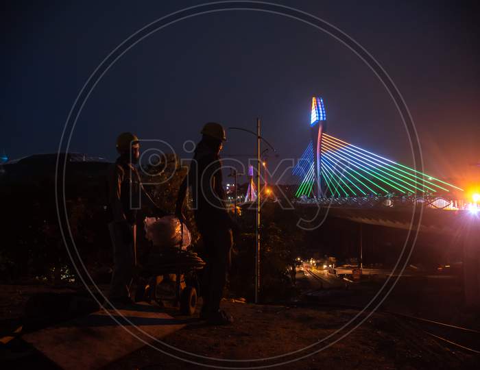 Workers give finishing touches to the Durgam Cheruvu Cable Bridge as it nears to be thrown open to public in a few days, August 14, 2020,Hyderabad