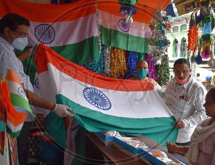 People purchasing tri colored national flags ahead of Independence day celebrations in Prayagraj, August 14, 2020