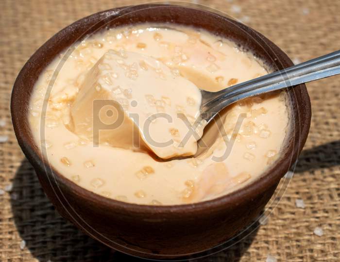 Curd Or Dahi (Yogurt) In An Earthen Bowl With Spoon And Selective Focus