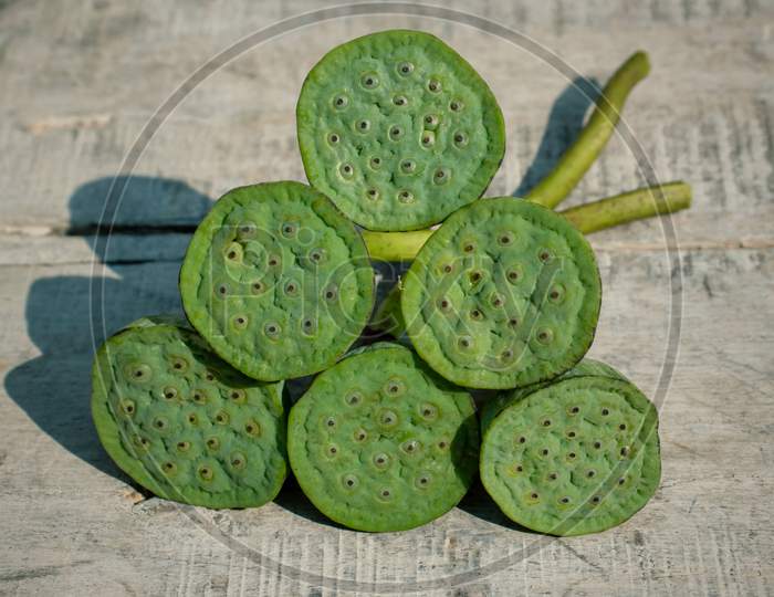 Indian Lotus Pods Or Nelumbo Nucifera Pods On Wooden Surface