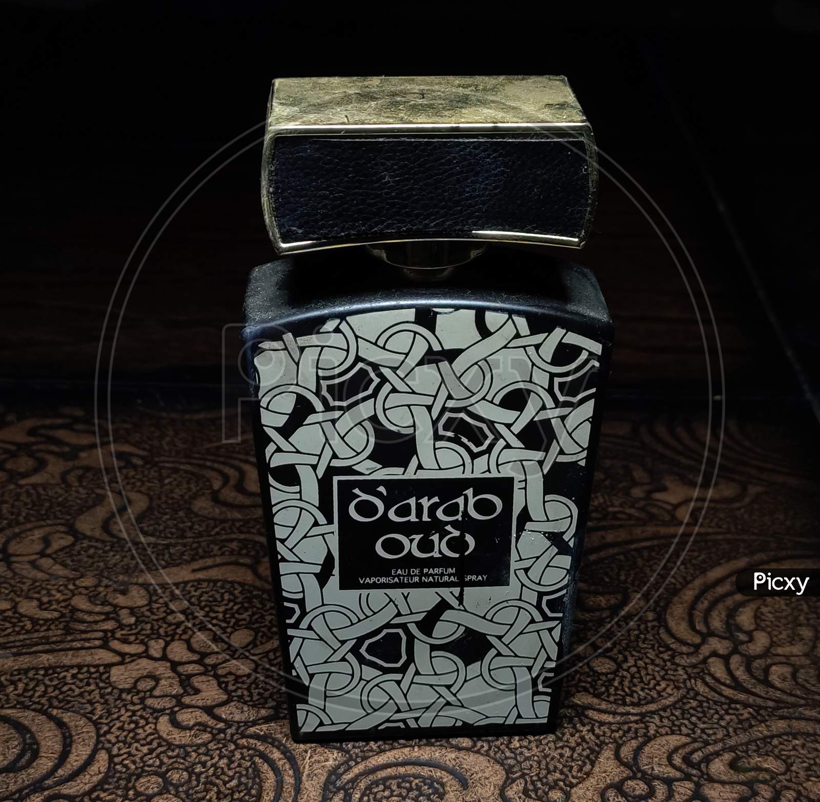 Beautiful perfume bottle on a Wodden table and black background
