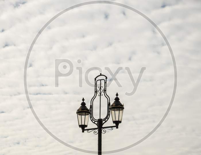 Twin Ornate Lamps On Top Of Lamp Post.