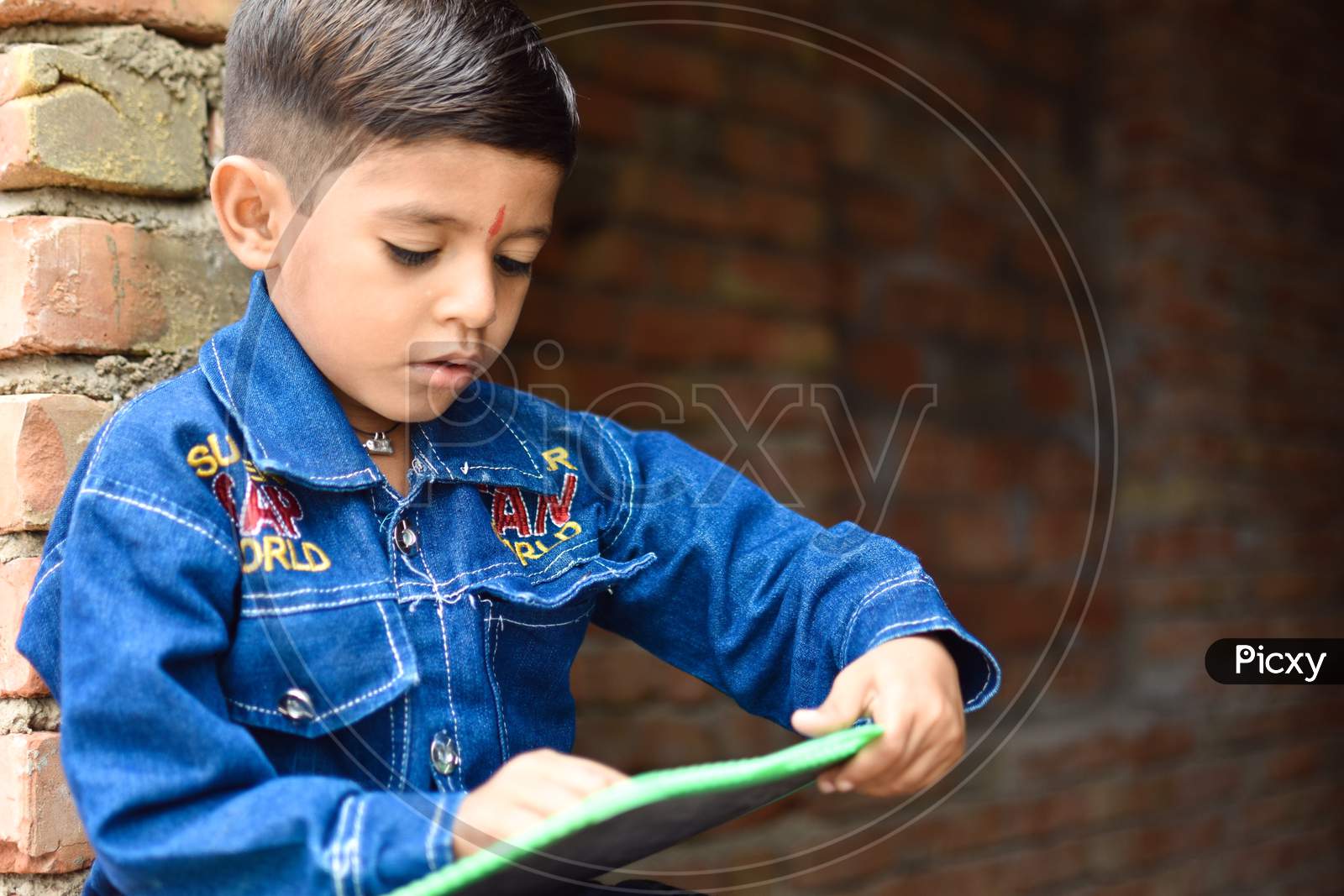 indian school kid learning abcd