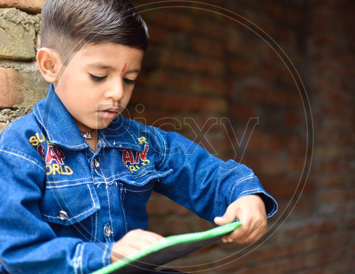 indian school kid learning abcd