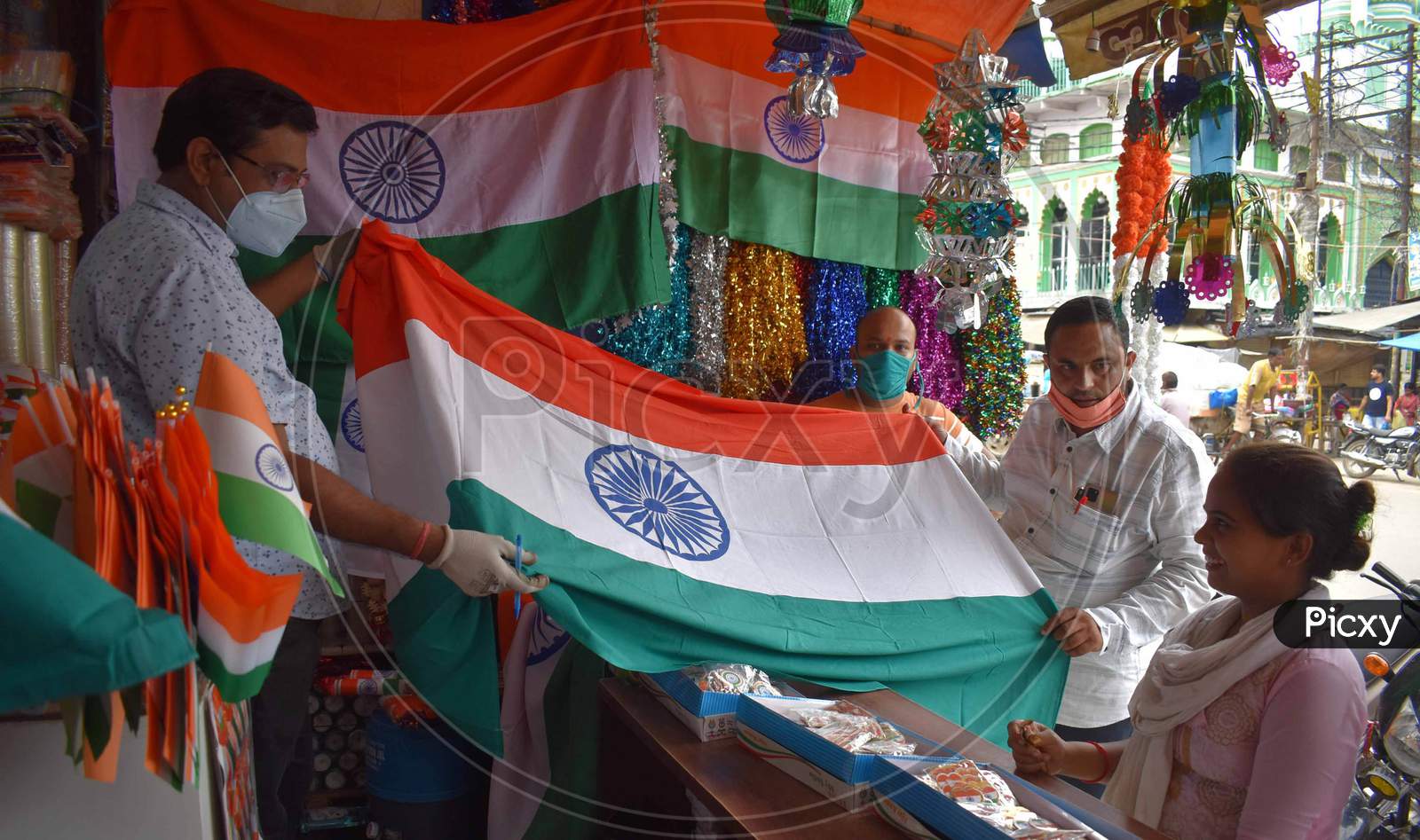 People purchasing tri colored national flags ahead of Independence day celebrations in Prayagraj, August 14, 2020