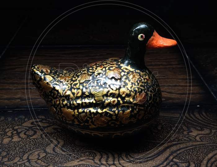 Wodden beautifully designed duck with black background