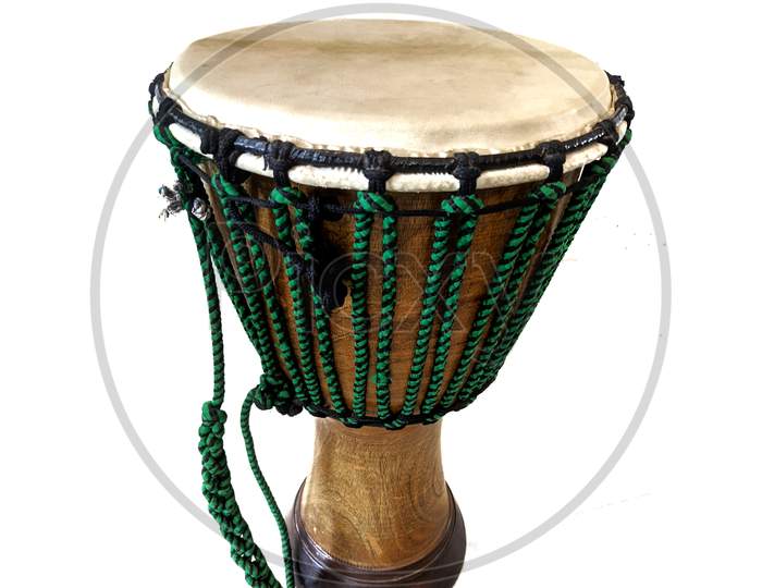 Djembe is a rope-tuned skin-covered goblet drum having shallow depth of field played with bare hands, originally from West Africa , isolated on white