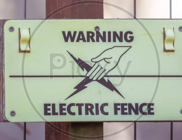 Warning Electric Fence Sign with Hand touching cable symbol