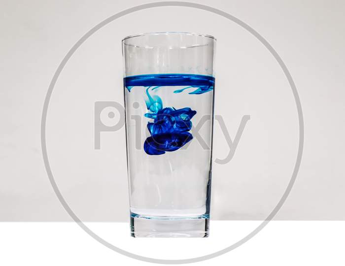 glass of water on the blue