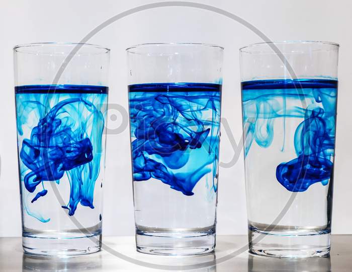 Three glass of water on the blue
