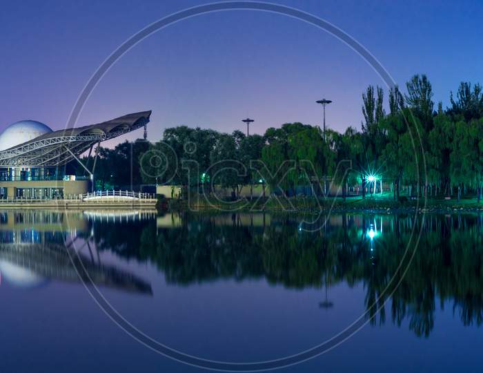 Night View Of Chaoyang Park, Largest Park In Beijing, China