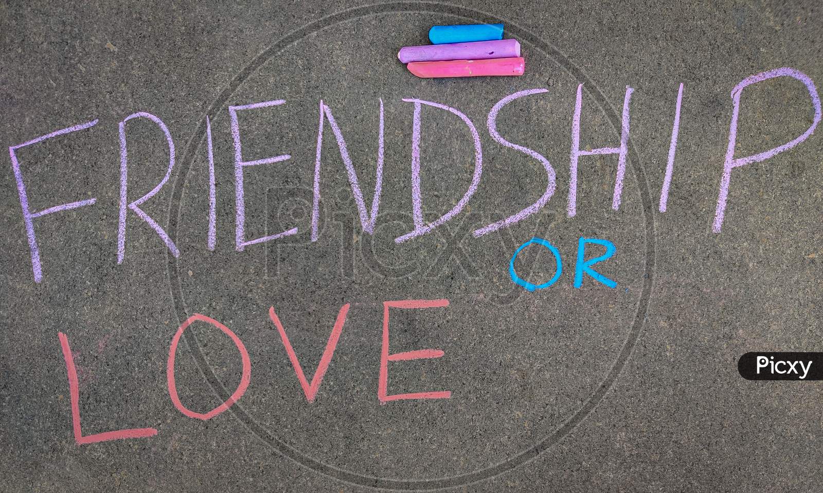 The Inscription Text On The Grey Board, Friendship Or Love. Using Color Chalk Pieces.