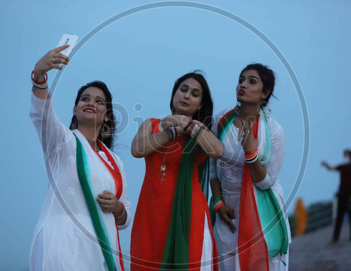 Women take a selfie to celebrate Independence day on the river bank of Sangam in Prayagraj, August 15, 2020.