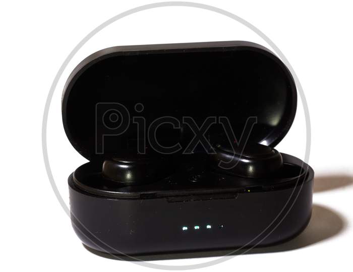 Pods Wireless Bluetooth Headset, with Wireless Charging Case on white background.