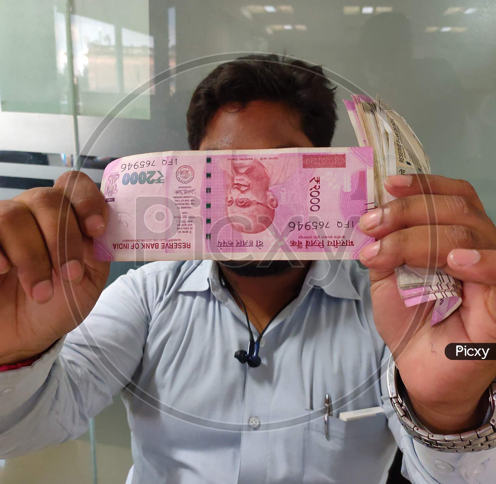 Man Checking 2000 Rupee Note.