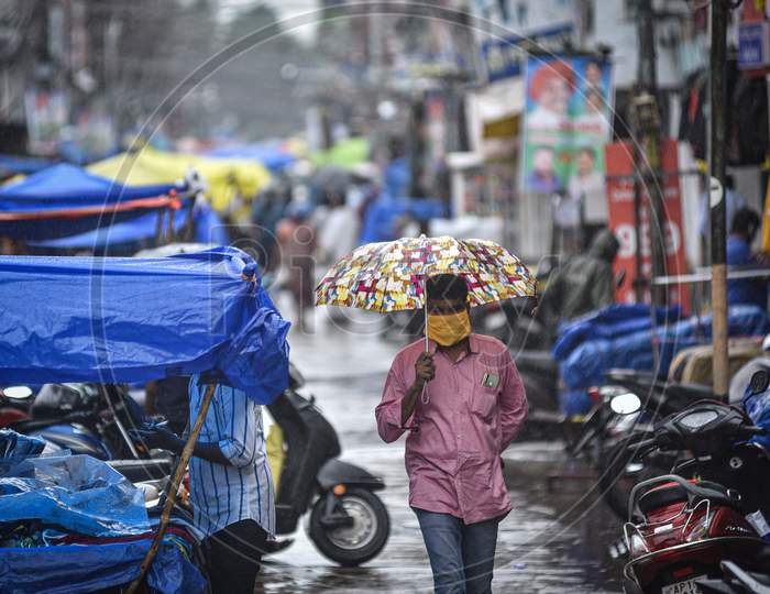 A Man Walks With An Umbrella During The Rain, At Besant Road, In Vijayawada On August 15, 2020.