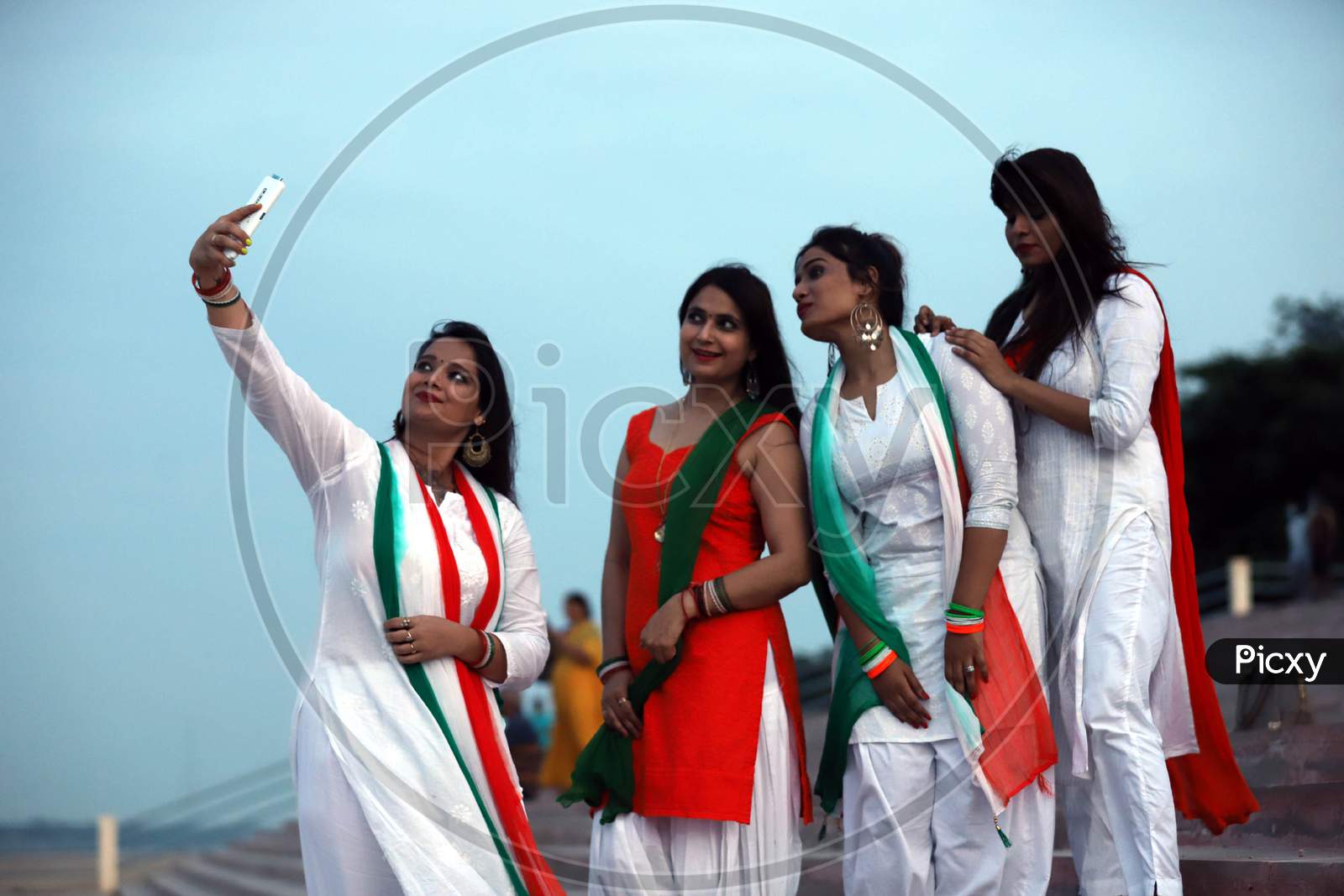 Women take a selfie to celebrate Independence day on the river bank of Sangam in Prayagraj, August 15, 2020.