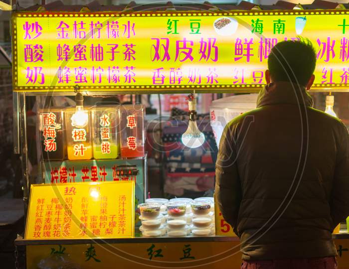 Man Buying Snacks At A Street Food Stall In Luoyang Old City, Henan, China