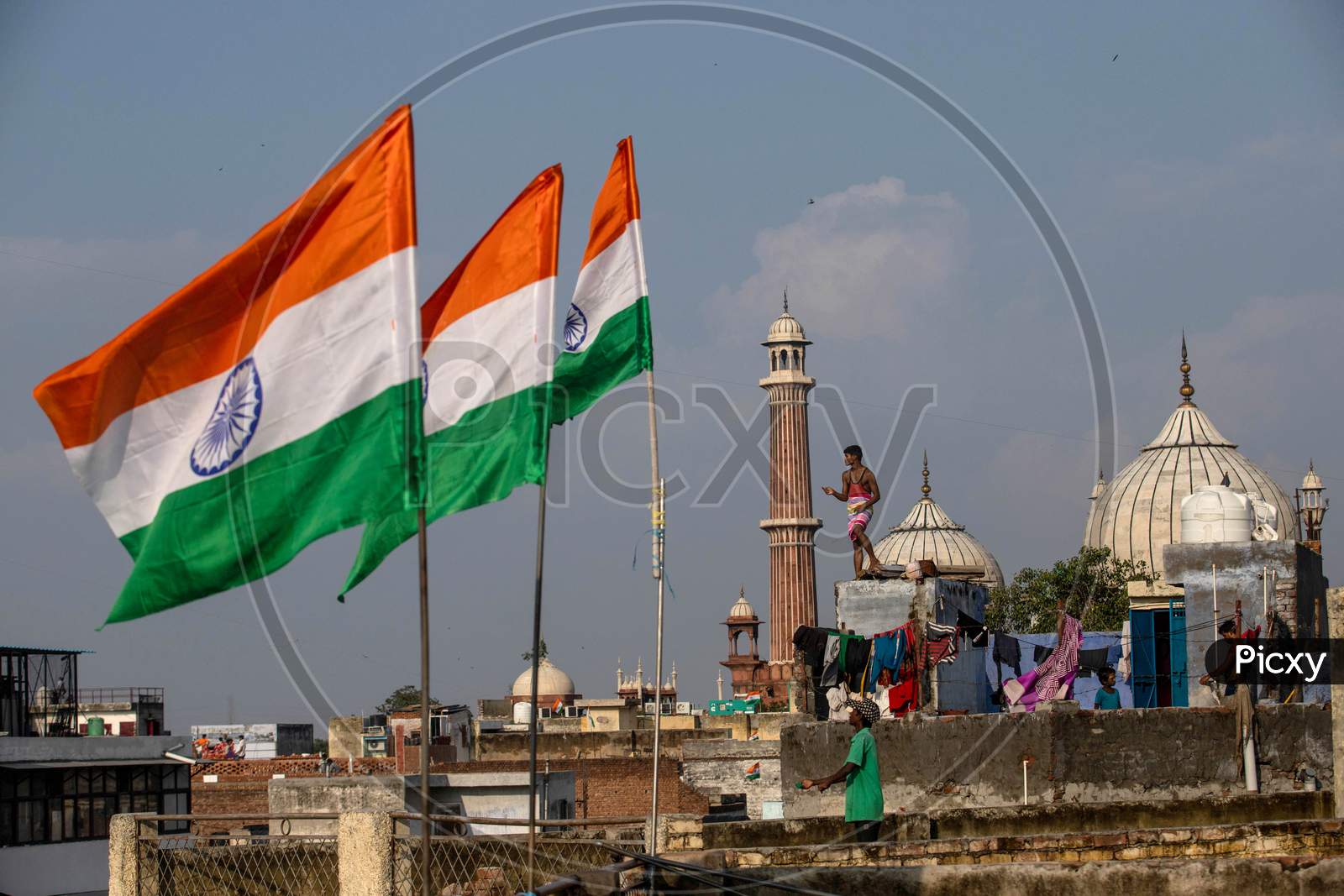 People fly kites from rooftops as they celebrate Independence Day in the old quarters of Delhi, India, August 15, 2020.
