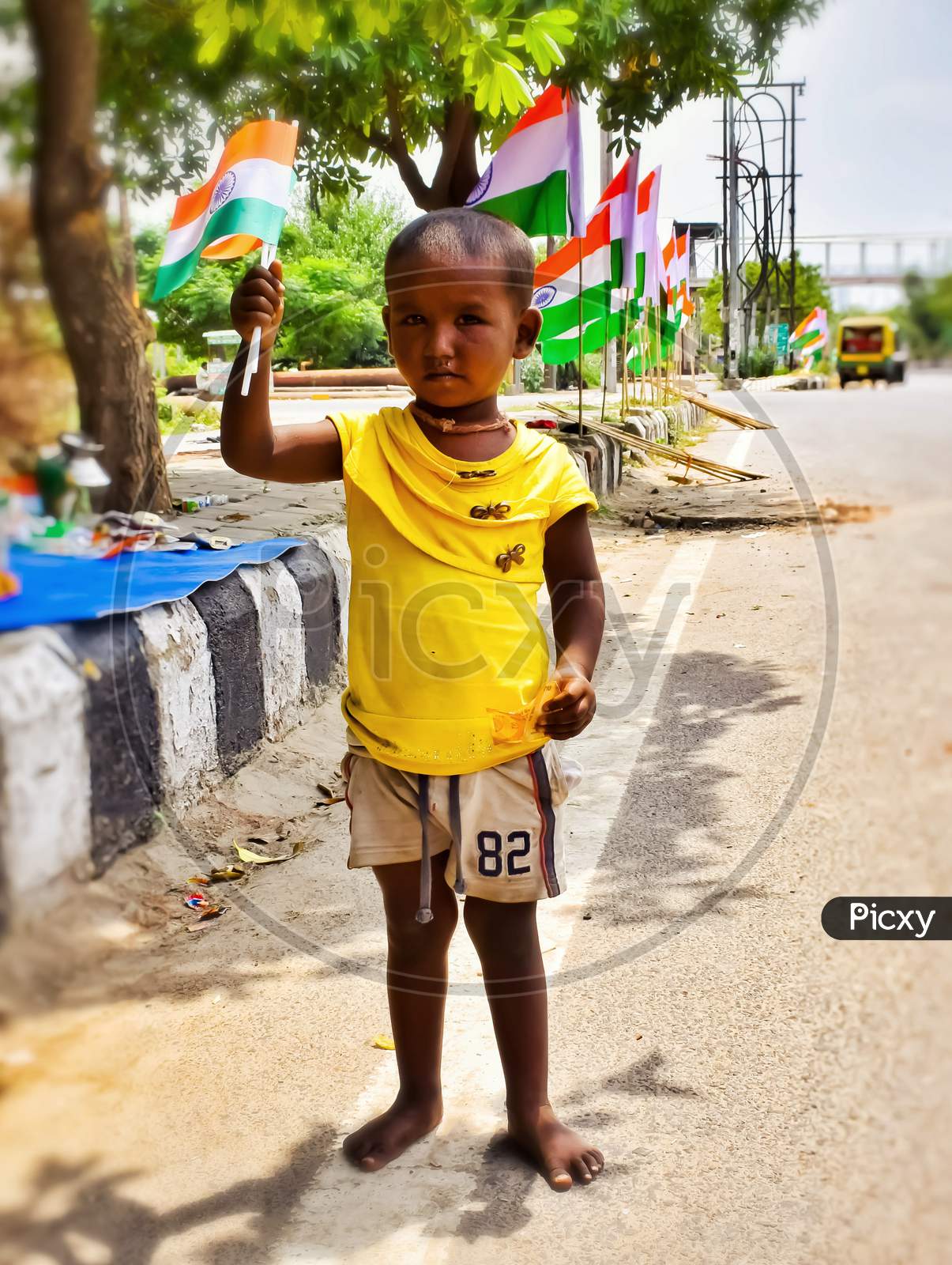 Child holding Indian flags