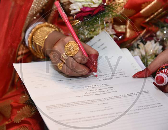 Bride Doing Signature On Marriage Register In India,