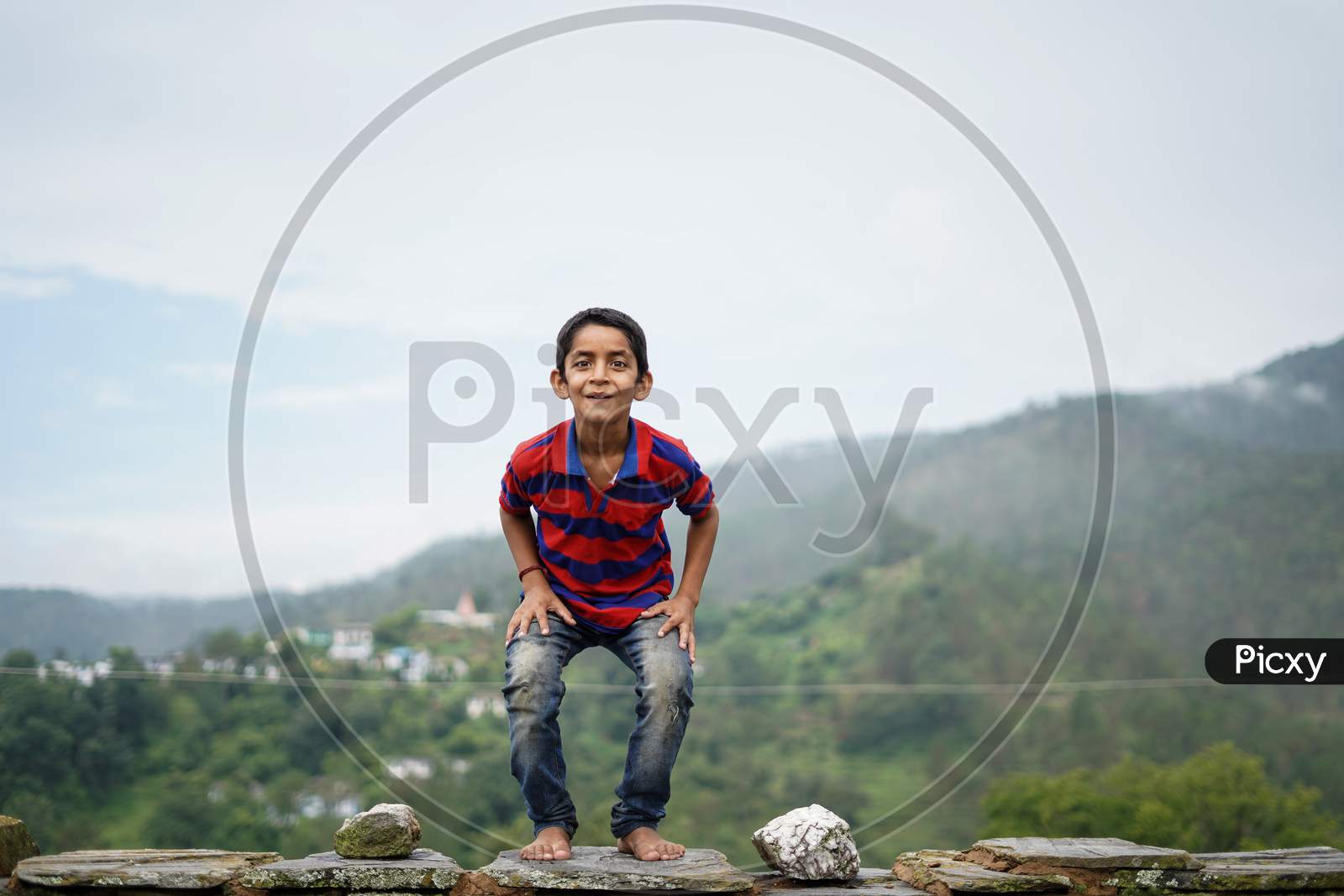 Little Indian Kid Jumping With Joy On The Roof