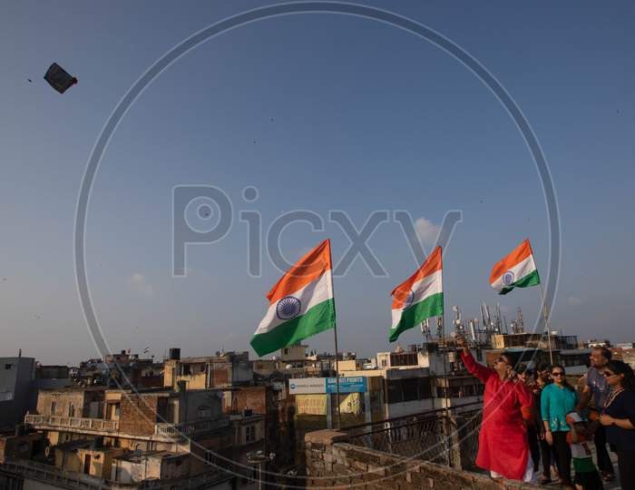 People fly kites from rooftops as they celebrate Independence Day in the old quarters of Delhi, India, August 15, 2020.