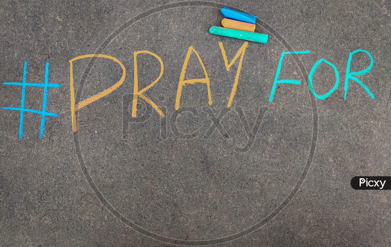 The Inscription Text On The Grey Board, #Pray For. Using Color Chalk Pieces.Copy Space