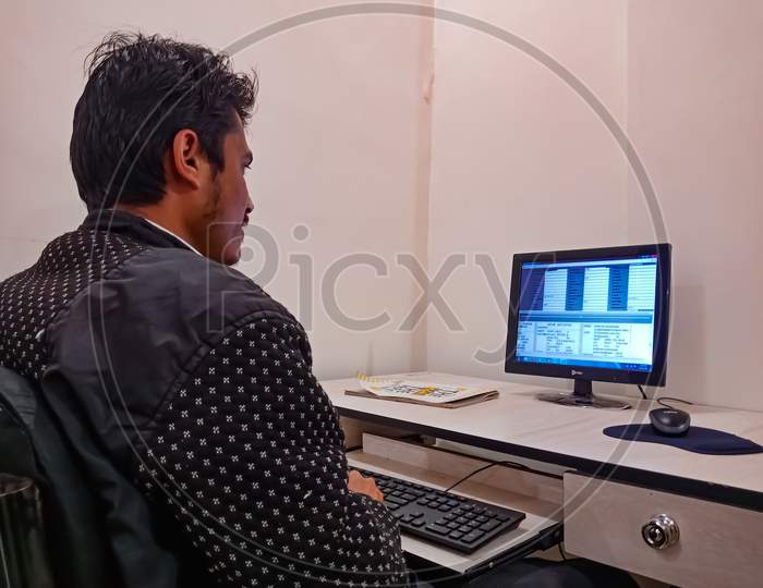 Indian Office Male Working Technically.
