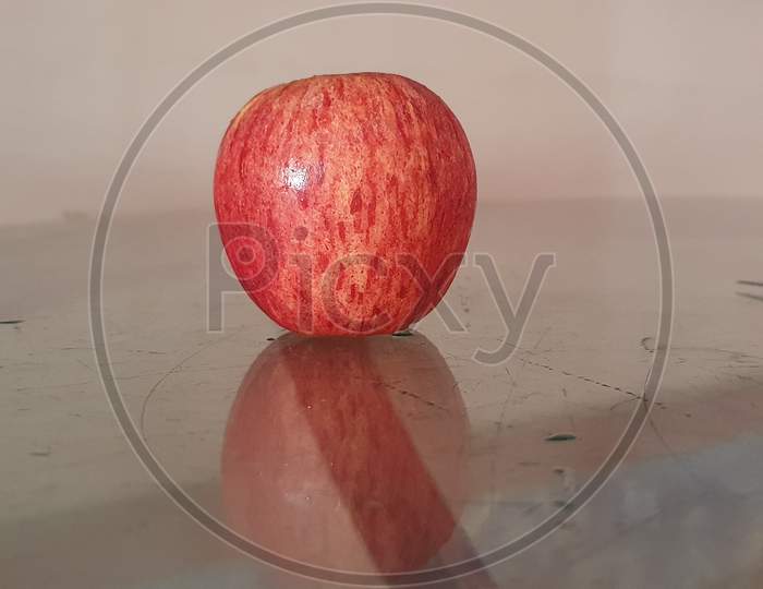 Red apple on the wooden chair.