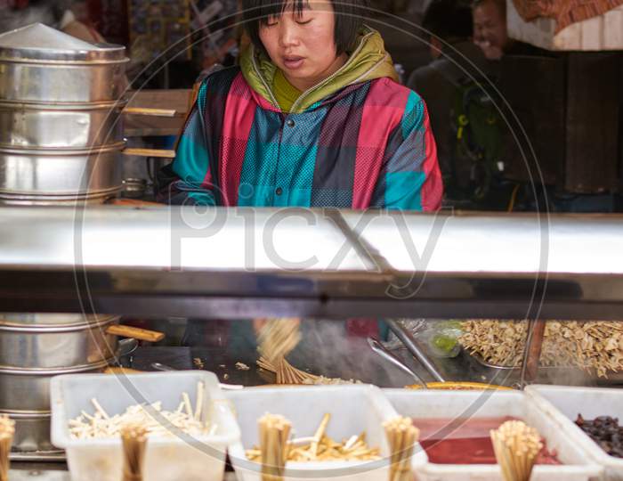 Vendor Girl Selling Snacks At A Street Food Stall In Luoyang Old City