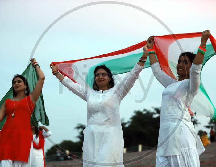 Women celebrate Independence day on the river bank of Sangam in Prayagraj, August 15, 2020.