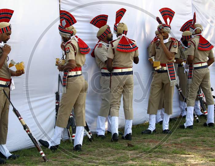 Policemen eat refreshments after taking part in India's 74th Independence Day celebrations In Chandigarh August 15, 2020
