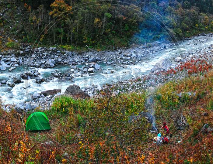 camping on river side in  in autumn forest uttarakhand india.