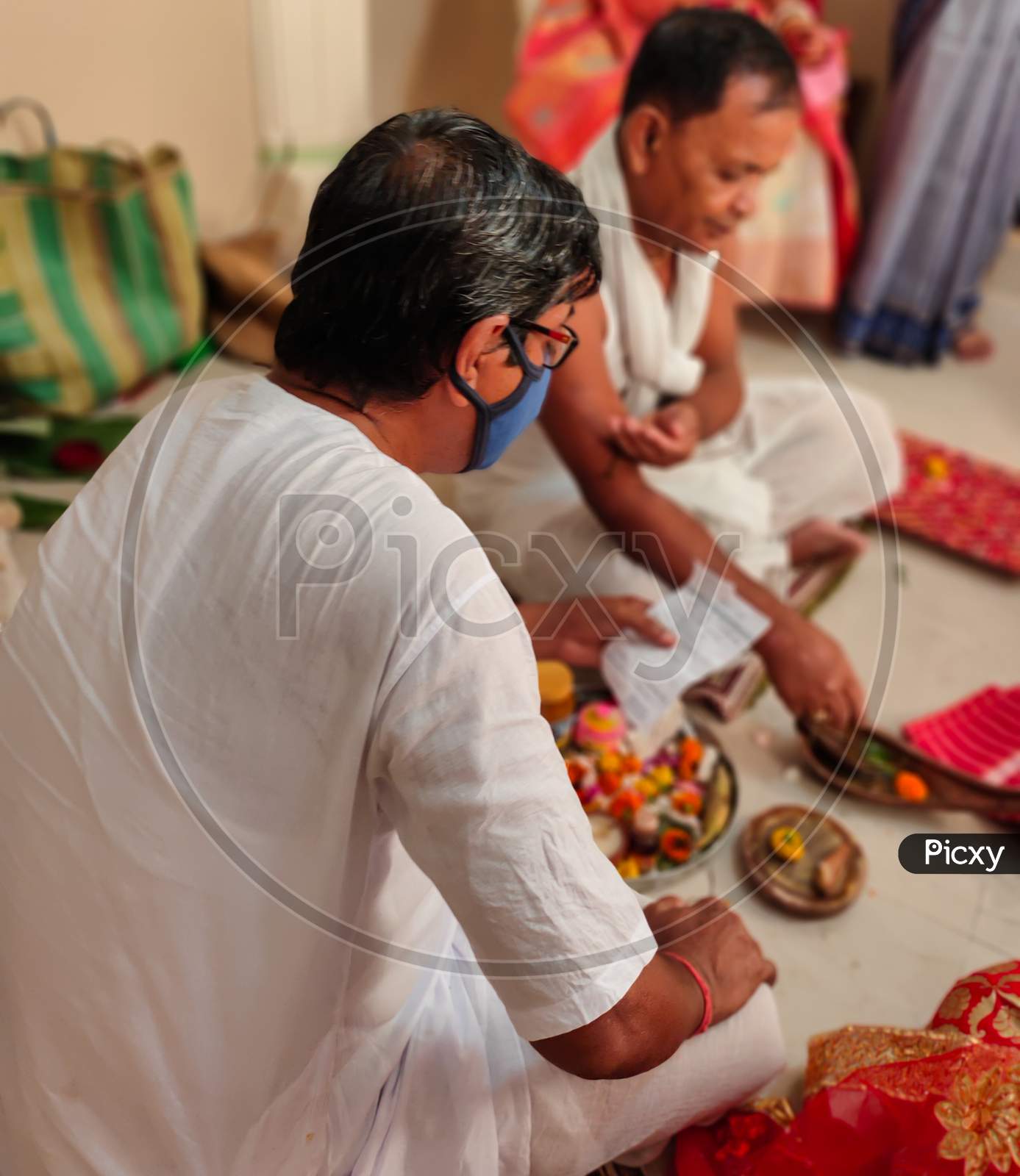 Bengali Hindu Priest Doing Rituals For Marriage With Mask On His Face.