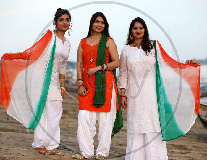 Women celebrate Independence day on the river bank of Sangam in Prayagraj, August 15, 2020.