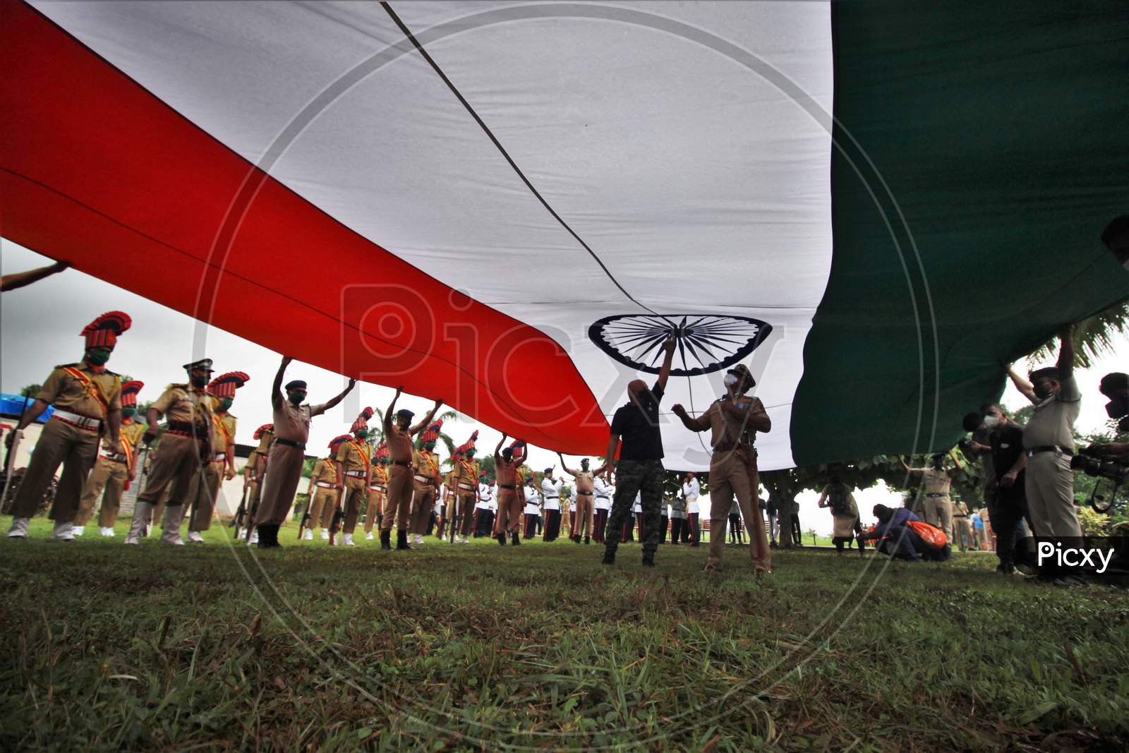 Policemen open a 100ft Tricolor Flag for flag hoisting function for Independence Day celebrations in Mumbai, India, August 15, 2020.