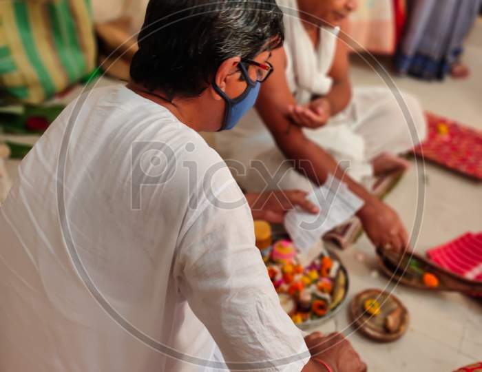 Bengali Hindu Priest Doing Rituals For Marriage With Mask On His Face.