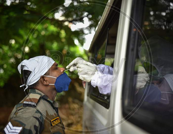 A medic collects a nasal sample of an army soldier for the COVID-19 test, In Vijayawada On August 12, 2020.