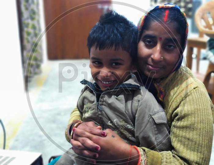 An Indian mother smiling with her child.