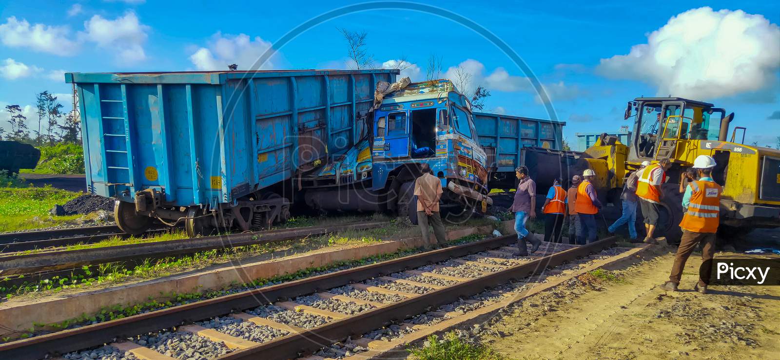 Paradeep, Odisha, India- July 22, 2020: A Rail Accident Near A Construction Site At Paradeep. Rail Wagons Hit A Truck And Has Risen Above It. Workers And A Bulldozer Are Engage For Removing Debris.