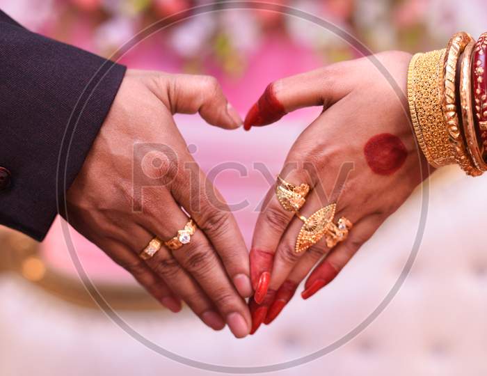 Heart Shape With Bride And Groom Hand.