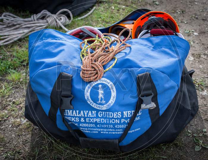Bag With Mountain Climbing Equipment With Ropes And Safety Helmets