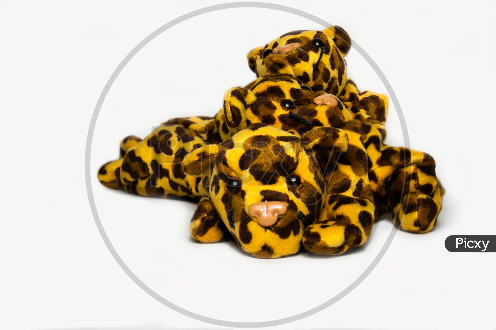 Three Playful Stuffed Leopard Soft Toys Isolated On A Plain White Background