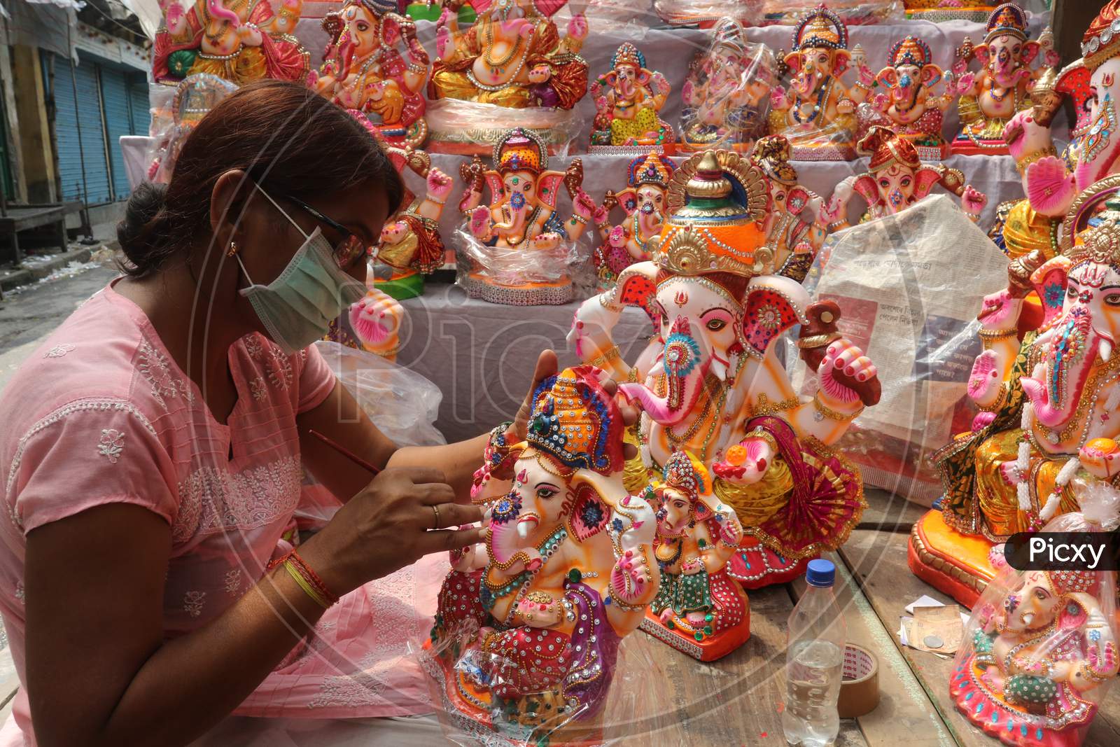 Ari woman artisan gives a finishing touch to an idol of Ganesh ahead of the Ganesh Chaturthi festival  (puja ) at her worship in Kumartuli North kolkata on Sunday 16 august 2020