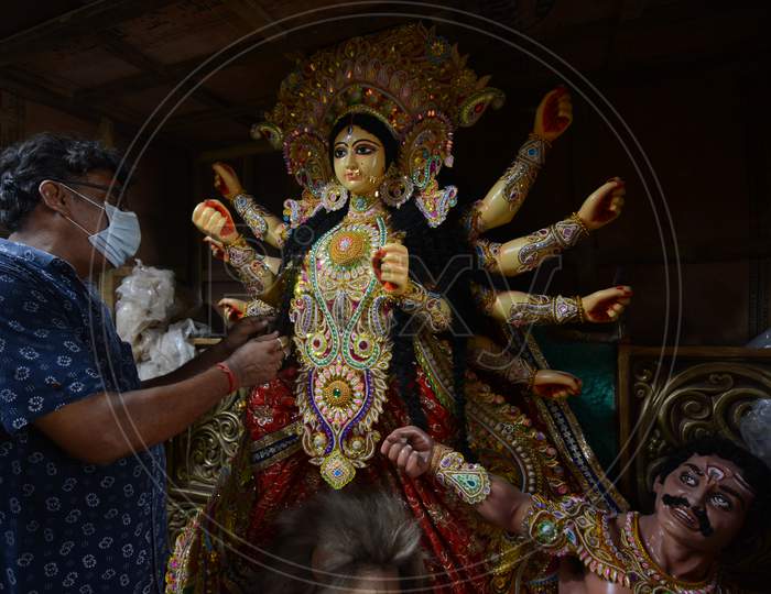 A man working on an idol for a puja in France. The order had come earlier this year but delivery has been delayed because of unlock.  on Sunday 16 august 2020