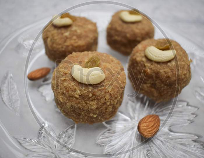 Prashad Ladoos Garnished With Fry Fruits For Ganesh Chaturthi Festival In India. Wish Happy Ganesh Chaturti With Sweet Dish Tasty Laddus