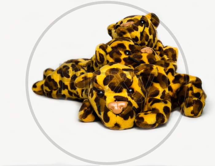 Three Playful Stuffed Leopard Soft Toys Isolated On A Plain White Background