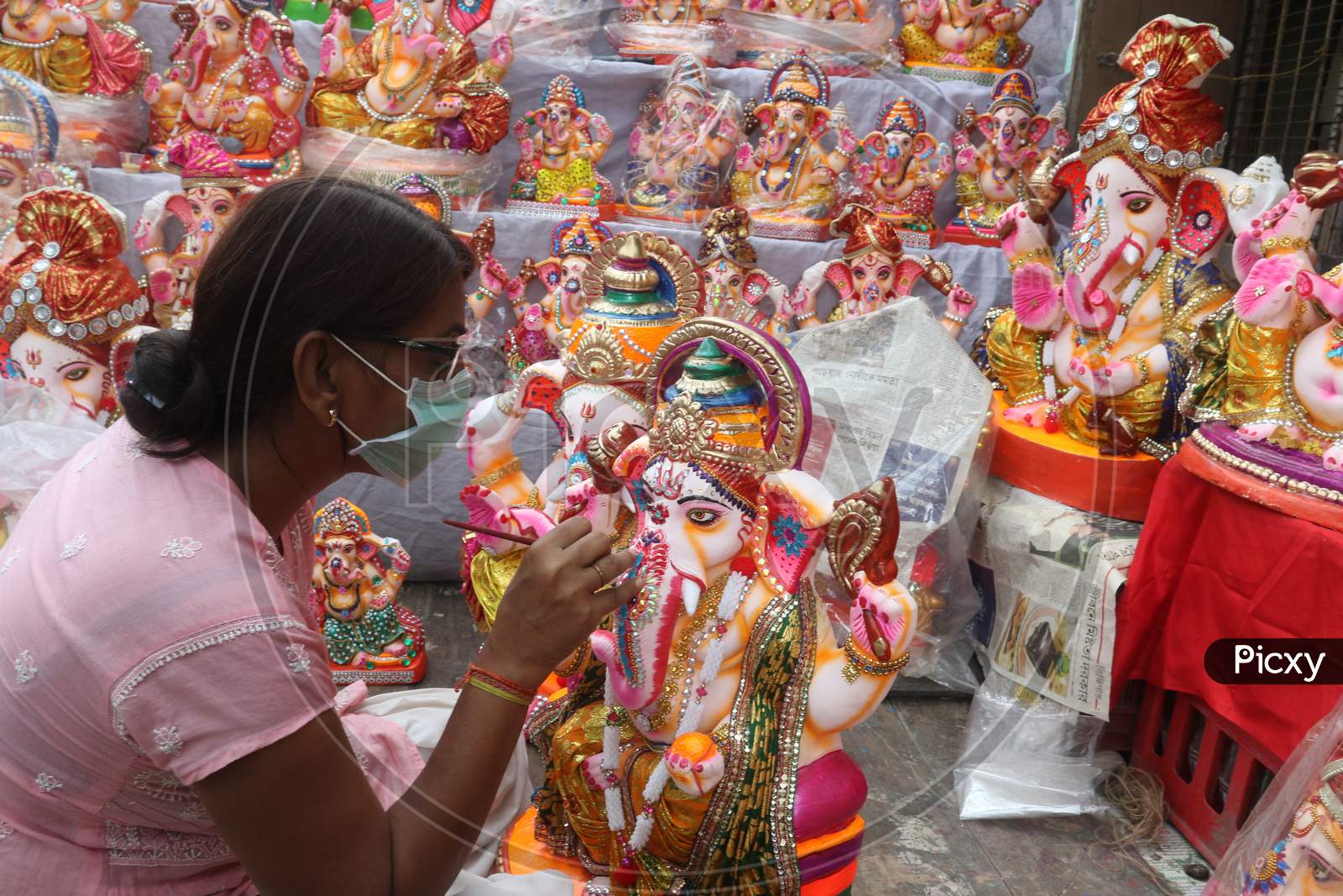 Ari woman artisan gives a finishing touch to an idol of Ganesh ahead of the Ganesh Chaturthi festival  (puja ) at her worship in Kumartuli North kolkata on Sunday 16 august 2020